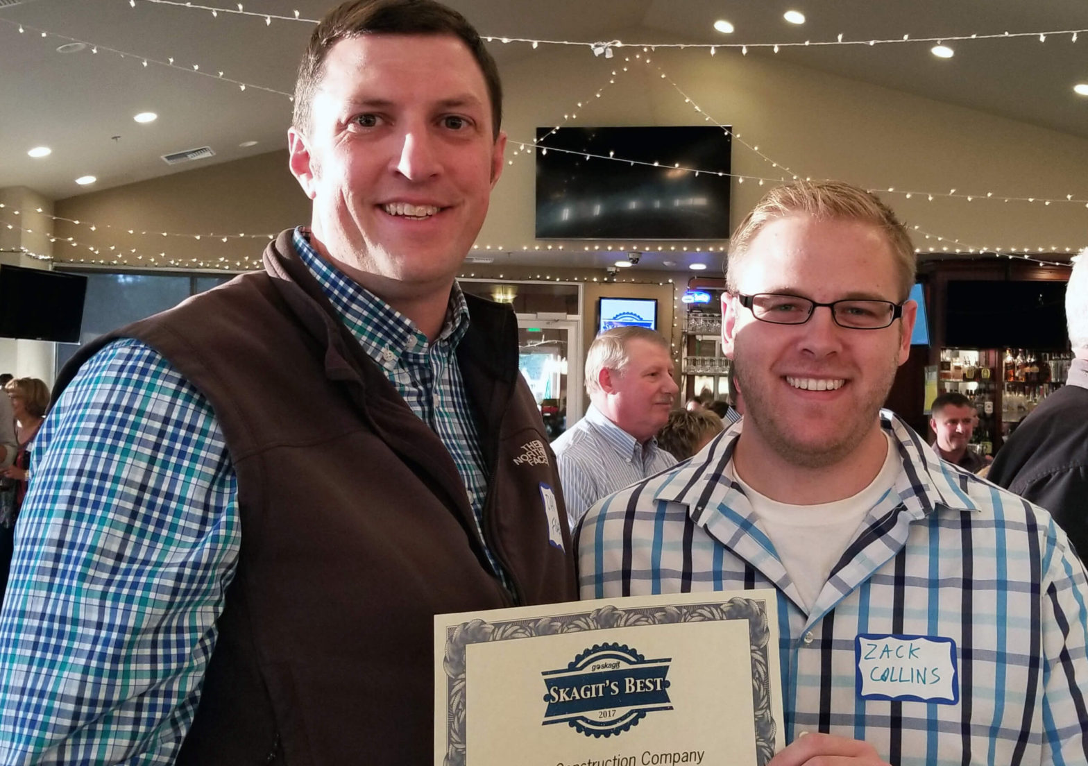 Dan Fisher and Zack Collins accept Best Construction Company award for Chad Fisher Construction